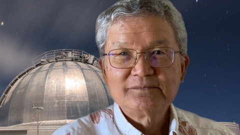 Dr. Alan Tokunaga headshot with telescope