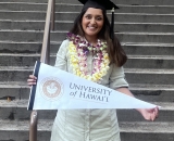 Manya Singh holding University of Hawaii banner